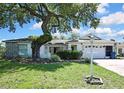 Lovely single-Gathering home with a well-maintained lawn, mature landscaping, and a two-car garage at 5042 Gaston St, Spring Hill, FL 34607
