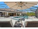 Covered patio features a luxurious pool, spa, outdoor seating, bar, and lounging area at 5043 Night Star Trl, Odessa, FL 33556