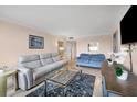 Inviting living room featuring tile floors, neutral paint, comfortable seating and glass table at 5855 Midnight Pass Rd # 201, Sarasota, FL 34242