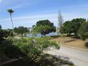 Scenic view of the community lake surrounded by mature trees and well-maintained green spaces under a blue sky at 6015 19Th N St # 301, St Petersburg, FL 33714