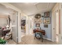 Tiled hallway decorated with pictures and a sewing machine at 616 Highview S Cir, Brandon, FL 33510