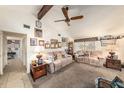 Living room with carpet, ceiling fan, sofas, and doorway to hallway at 616 Highview S Cir, Brandon, FL 33510