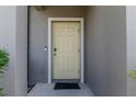 Close-up of the front door with secure keyless entry, doorbell and clean, modern trim at 6653 Mineral Springs Rd, New Port Richey, FL 34653