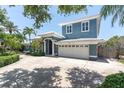 Charming exterior view of a two-story home with a large driveway and mature landscaping at 860 Harbor Is, Clearwater Beach, FL 33767
