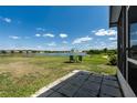 The property features a spacious backyard with views of the lake, as well as seating to enjoy the view at 9031 Sienna Moss Ln, Riverview, FL 33578