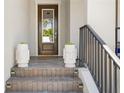 Inviting front porch and stairs with decorative planters leading to the front door at 916 Seagrape Dr, Ruskin, FL 33570