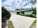 Attractive single-story home with a spacious driveway and well-maintained landscaping at 924 Highview Dr, Palm Harbor, FL 34683