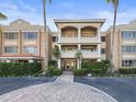 Stately multi-story building with lush landscaping and a circular driveway entrance at 950 Broadway # 103, Dunedin, FL 34698