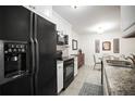 Well-equipped kitchen featuring granite countertops, modern appliances, and ample storage at 950 Broadway # 103, Dunedin, FL 34698