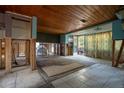 Open living room with wood ceiling, tile floors, and natural light, ready for renovation and personalization at 9810 Parsons St, Tampa, FL 33615