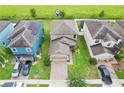An aerial view of a neighborhood showcases well-manicured lawns and houses with solar panels on some rooftops at 11871 Crestridge Loop, Trinity, FL 34655