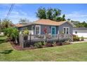 Inviting home with a welcoming front deck and lush landscaping, enhancing its curb appeal at 1209 W Adalee St, Tampa, FL 33603