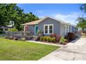 Attractive home with a front deck and well-maintained landscaping creating a warm and inviting exterior at 1209 W Adalee St, Tampa, FL 33603