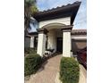 Inviting front entrance featuring an archway, columns, and a cozy seating area at 13172 Green Violet Dr, Riverview, FL 33579