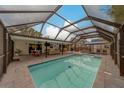 Stunning screened-in pool area with comfortable lounge seating, perfect for relaxation and entertainment at 1450 Palmetto St, Clearwater, FL 33755