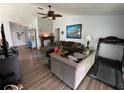 Open living room featuring modern decor, hardwood floors, and ample natural light at 16035 Grass Lake Dr, Tampa, FL 33618