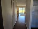 Inviting hallway leading to a bright living area with hardwood floors and ample storage at 1624 Stickney Point Rd # 24-101, Sarasota, FL 34231