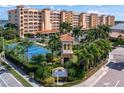 Bahia Vista community featuring a tennis court, lush landscaping, and picturesque buildings with Mediterranean-style architecture at 17735 Gulf Blvd # 304, Redington Shores, FL 33708