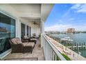 Waterfront condo balcony with comfortable seating area overlooking beautiful marina and waterfront views at 17735 Gulf Blvd # 304, Redington Shores, FL 33708