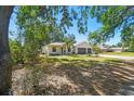 Lovely home with a well-manicured lawn, mature trees, and a convenient two-car garage at 18902 Spring Hollow Dr, Lutz, FL 33559