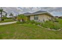 Lovely single-story home featuring lush greenery and charming landscaping at 1915 W Del Webb Blvd, Sun City Center, FL 33573