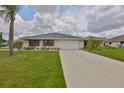 Beautiful single-story home featuring a lush green lawn and well-maintained landscaping at 1915 W Del Webb Blvd, Sun City Center, FL 33573