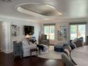 Bright living room with hardwood floors, stylish furnishings, and a unique recessed ceiling design at 209 Rosery Rd, Belleair, FL 33756