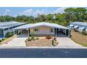 Charming single-story home with a carport, well-maintained landscaping, and welcoming curb appeal at 210 N Saint Thomas Cir, Apollo Beach, FL 33572