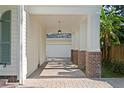 Attached covered parking area with brick pillars, offering shade and convenience at 2714 W Jetton Ave, Tampa, FL 33629