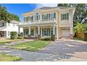 Elegant two-story home showcasing a welcoming front porch and a convenient side-entry garage at 2714 W Jetton Ave, Tampa, FL 33629