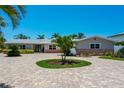 Charming home with a circular driveway and lush tropical landscaping at 2788 70Th S Ave, St Petersburg, FL 33712