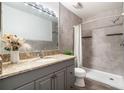 Updated bathroom with gray tiled walk-in shower, modern vanity, and sleek fixtures at 3137 Mission Grove Dr # 3137, Palm Harbor, FL 34684