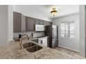 Well-lit kitchen featuring granite countertops, stainless steel appliances, and ample cabinet space at 3137 Mission Grove Dr # 3137, Palm Harbor, FL 34684
