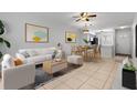 Bright living room with stylish furniture, modern art, and open floor plan to dining area at 3137 Mission Grove Dr # 3137, Palm Harbor, FL 34684