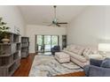 Inviting living room with a vaulted ceiling, comfortable seating, and sliding doors to the outdoor area at 3342 Waterford Dr, Clearwater, FL 33761