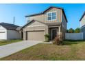 Attractive two-story home with a two-car garage, front yard, and a welcoming front entrance at 34847 Daisy Meadow Loop, Zephyrhills, FL 33541