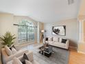 Bright and airy living room featuring a large window, hardwood floors, and neutral decor at 441 Thicket Crest Rd, Seffner, FL 33584