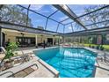 Stunning screened-in pool area with clear blue water and ample space for relaxation and entertaining at 6514 Sunhigh Dr, New Port Richey, FL 34655