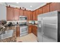 Kitchen featuring stainless steel appliances, granite countertops, and ample wood cabinetry at 6902 47Th N Ln, Pinellas Park, FL 33781