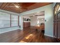 Spacious living room boasting hardwood floors, a wood ceiling, and an inviting open layout at 7108 N Howard Ave, Tampa, FL 33604
