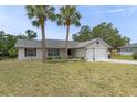 Cozy home with neatly kept lawn and a two-car garage in a tranquil neighborhood at 7337 Glasgow Rd, Weeki Wachee, FL 34613