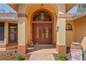Close up of the home's impressive double-door front entrance, showcasing its architectural detail at 7353 Dogwood Cres, Spring Hill, FL 34607