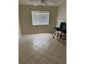 A bright and airy bedroom with a window with blinds, ceiling fan, and tile flooring at 7360 Ulmerton Rd # 20F, Largo, FL 33771