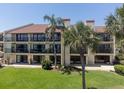 Back of condo building showing balconies and lawn, ideal outdoor space at 7500 Sunshine Skyway S Ln # 201, St Petersburg, FL 33711