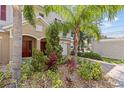 Townhouse with meticulously maintained landscaping, front lawn and paved driveway at 800 Callista Cay Loop, Tarpon Springs, FL 34689