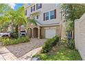 Inviting townhouse with meticulously maintained landscaping, front lawn and paved driveway at 800 Callista Cay Loop, Tarpon Springs, FL 34689