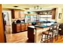 Traditional style kitchen featuring wood cabinets, a peninsula with bar seating, and a window over the sink at 8313 Cavalry Dr, Hudson, FL 34667