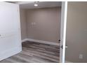 Neutral bedroom showcasing fresh paint, new flooring, and white trim, with closet and ensuite access at 10116 N Highland Ave, Tampa, FL 33612