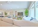 Bright living room featuring comfortable seating, a large window, and modern decor at 110 8Th St, Belleair Beach, FL 33786