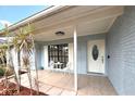 Charming front porch with seating, leading to an elegant front door at 11303 Hollyglen Dr, Tampa, FL 33624